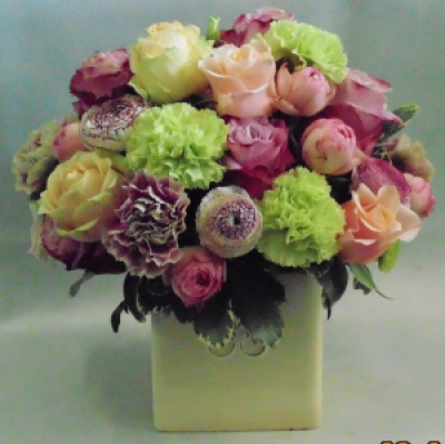 sweetness - an arrangement of flowers in a cube container available in the colours of your choice and using seasonal flowers to create an array of colour